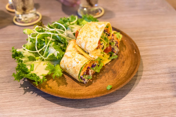 fresh tortilla wraps with vegetables on the plate
