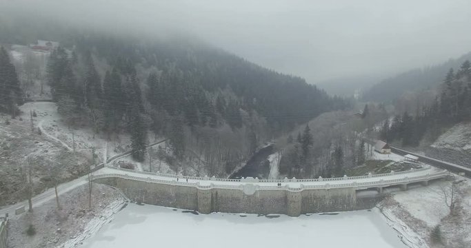 Aerial: The reservoir and bridge of Spindler Mill, Czech Republic in winter