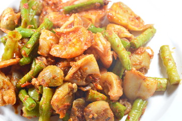 spicy stir fried mixed seafood with yard long bean curry on dish