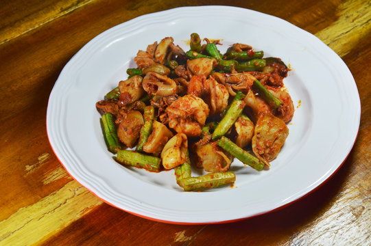 spicy stir fried mixed seafood with yard long bean curry on dish