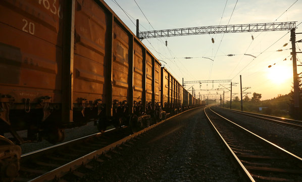 Freight train moving on the tracks at sunset