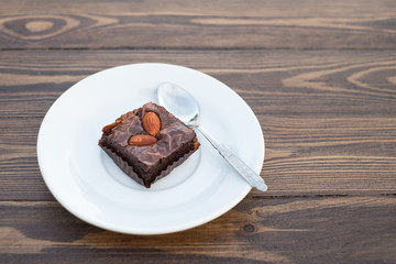 Homemade chocolate brownie with almond on wood table