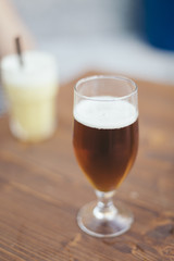 Blond fresh beer close up on a pub isolated on a wooden table