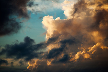 Colorful huge clouds a blue sky background at sunset.