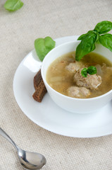 soup meatballs white plate basil bread