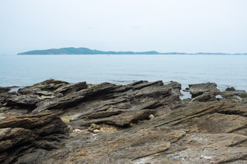 Rock on sea coastline with seascape view