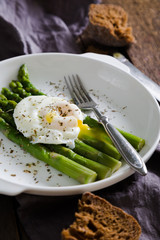 Boiled asparagus with poached egg