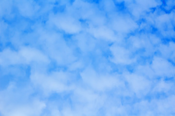 Fuzzy cloud on the blue sky, abstract background.