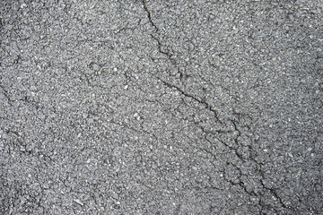 Crack asphalt road texture background closeup