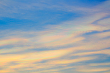 Obraz premium Colorful iridescent cloud, Beautiful Rainbow cloud. Blue sky at sunset, abstract background.