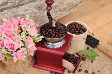 Coffee grinder with coffee beans and cup espresso.
