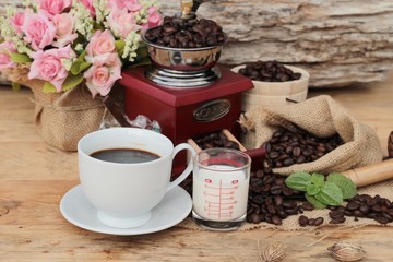 Obraz na płótnie Canvas Coffee grinder with coffee beans and cup espresso.