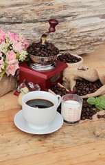 Coffee grinder with coffee beans and cup espresso.