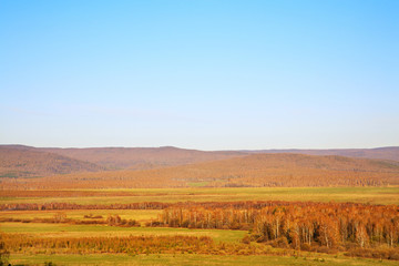 Fototapeta na wymiar Scenic autumn landscape. meadow, forest and mountains