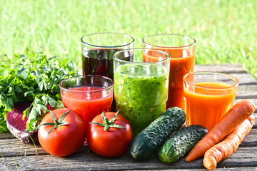Glasses with fresh organic detox juices in the garden