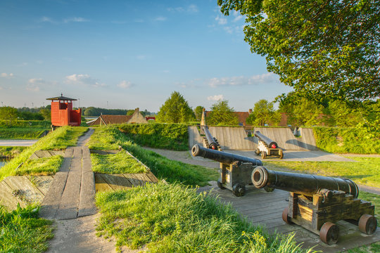 A battery of 4 old gunpowder guns on gun carriage and an observatory  in the historic fortress town of Bourtange, Groningen in the Netherlands.