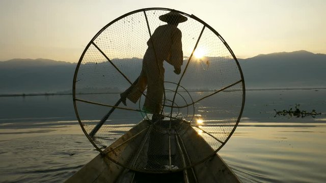 Silhouette fishermen in Inle Lake at sunrise, Shan State, Myanmar