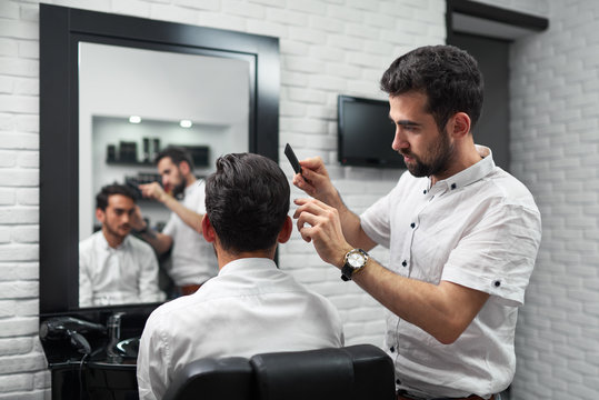 client watching prosess of combing hair by hairstylist