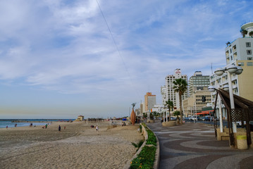 Fototapeta na wymiar Tel-Aviv, Israel. View of city beach and embankment in evening in the city of Tel- Aviv