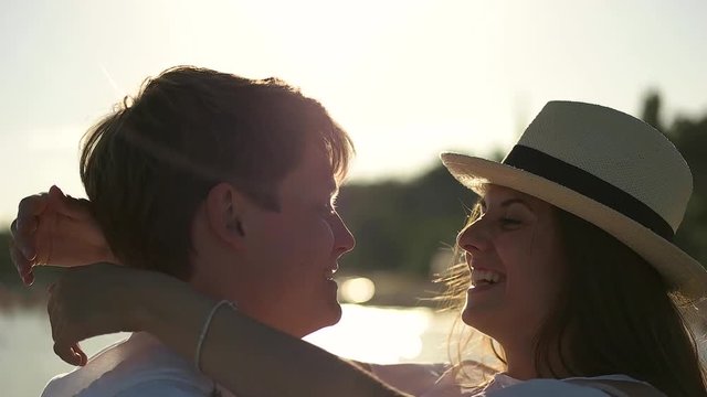 Couple smiling and kissing close up.