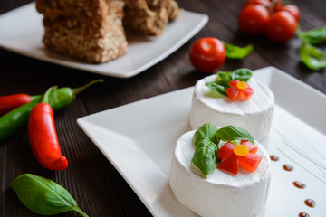 Camembert cheese with whole wheat bread and basil