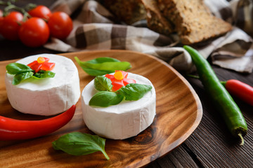 Camembert cheese with whole wheat bread and basil