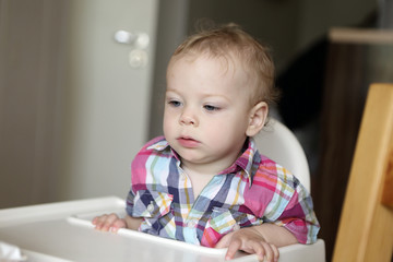 Naklejka premium Child at high chair
