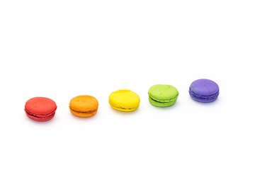 Testy french colorful macarons in a row, isolated on white