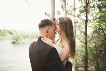 Kissing wedding couple in spring nature close-up portrait