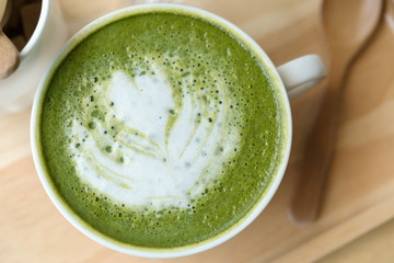 Hot green tea set on a wooden table in a coffeshop