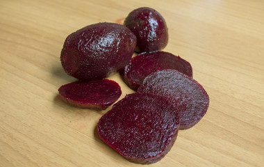 slices of red beet on the wooden background