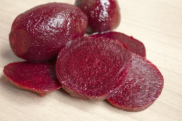slices of red beet on the wooden background