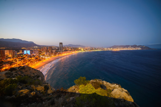 View of the coastline in Benidorm at sunset with city lights
