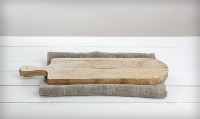 Empty cheeseboard on white wooden table.