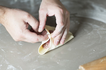 The process of sculpting meat dumplings. The chef cook dinner with dough and flesh stuffing. 