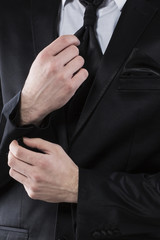 Businessman Fixing Cufflinks his Suit