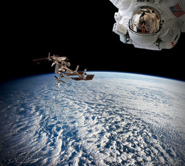Planet Earth astronaut spaceman helmet suit outer spacewalk international space station. Elements of this image furnished by NASA.