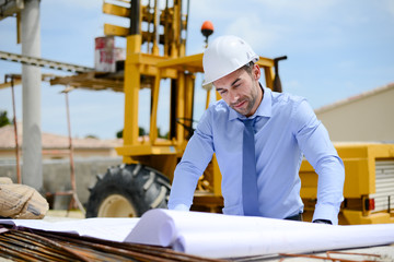 portrait of handsome young man architect on a building industry construction site