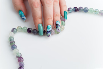 Closeup of woman hand with colorful nails