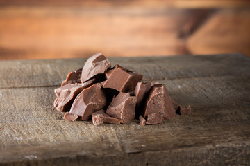 Pieces of milk Chocolate on wood