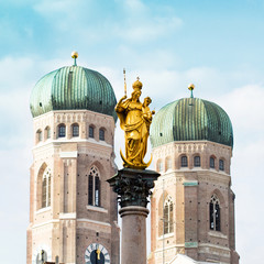 The Golden Mary's Column opposite the towers of the Cathedral of Our Dear Lady in Munich, Germany