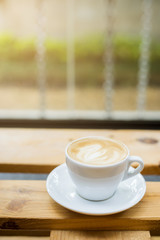 hot latte art on wood table background