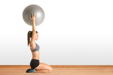 Fit Woman Holding a Pilates Ball