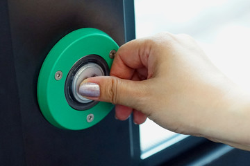A woman presses the green button to exit.