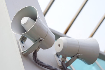 A pair of megaphones on the wall of the building.