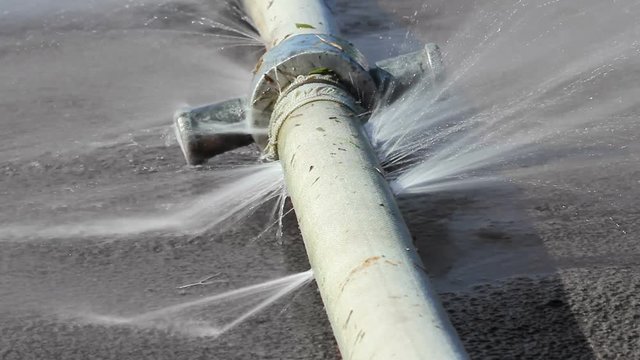 Seamlessly looping water leaking from hole in a industrial hose.