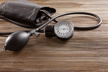 Medical manometer on a wooden background