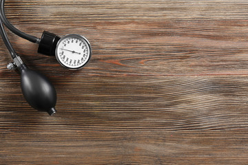 Medical manometer on a wooden background