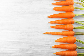Fresh carrots on wooden background