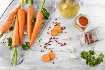 Healthy food and ingredients with carrots, parsley and spices on wooden background